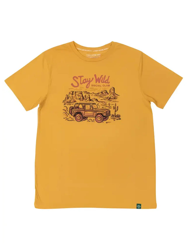 Mustard yellow t-shirt with a graphic of an off-road vehicle in a desert landscape and Stay Wild Social Club text