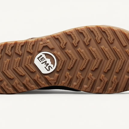 Brown rubber sole of a shoe with a textured tread pattern and a white Lems logo