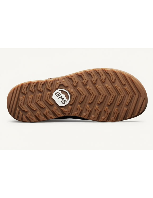 Brown rubber sole of a shoe with a textured tread pattern and a white Lems logo