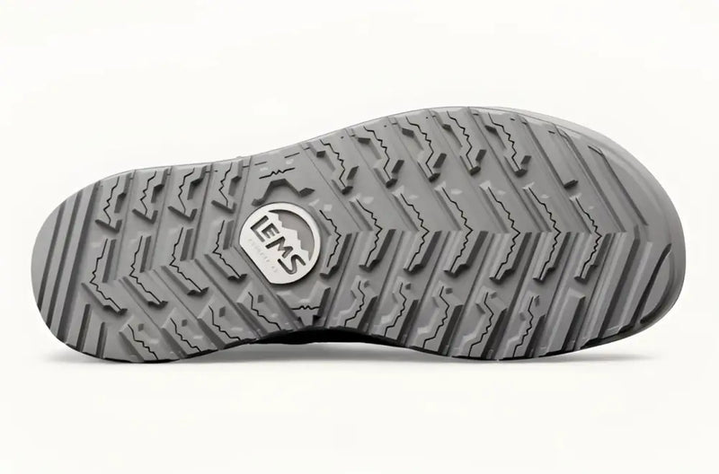 Underside of a gray shoe sole with a textured tread pattern and the LEMS logo
