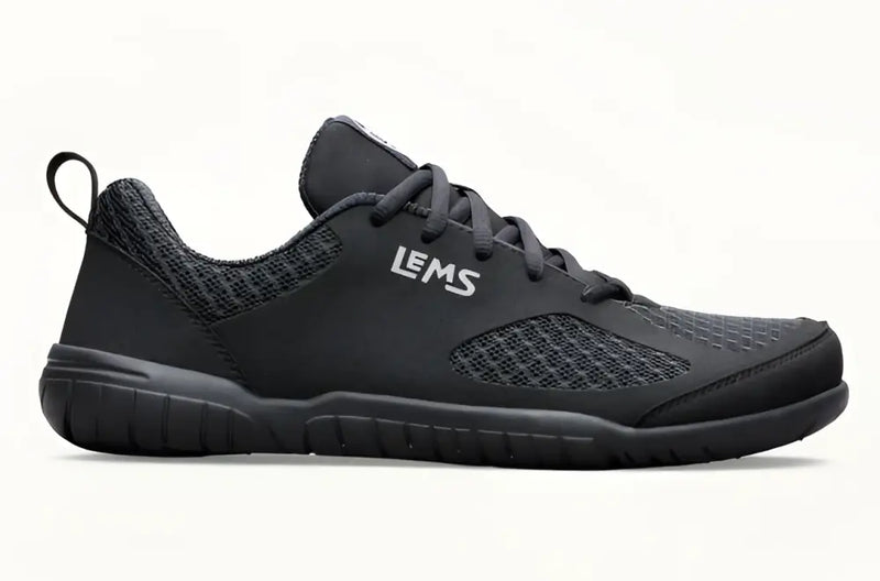 Black Lems shoe with mesh upper and black laces on a white background