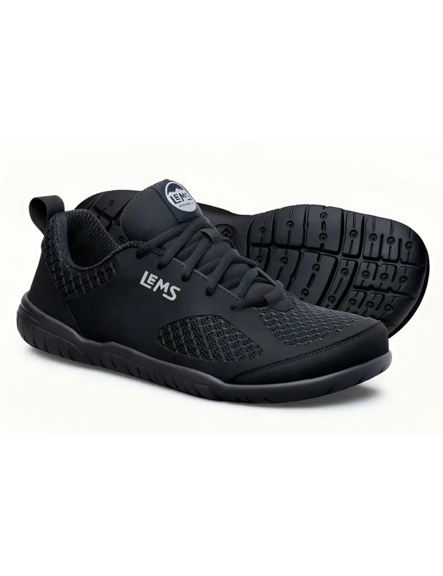 Pair of black Lems Primal Pursuit shoes with textured mesh and solid black accents