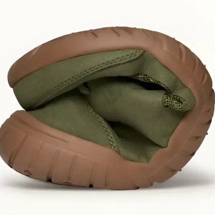 Flexible green shoe with brown sole bent in half