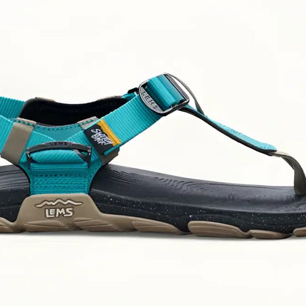 Teal and black Lems Primal Pursuit sandal with a tan sole and speckled black footbed