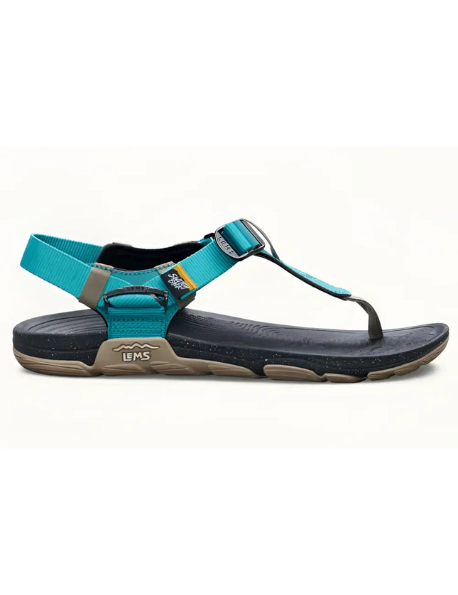 Teal and black Lems Primal Pursuit sandal with a tan sole and speckled black footbed