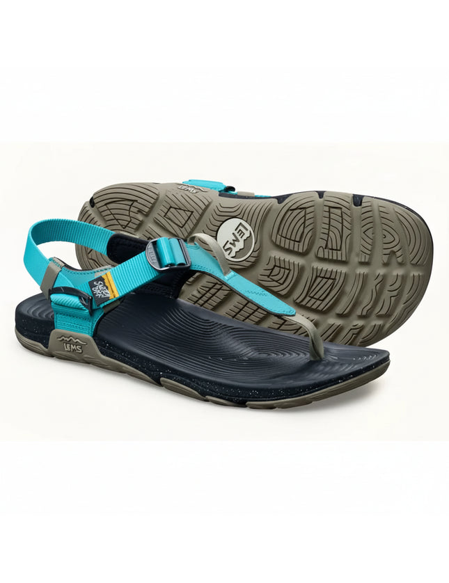 Pair of Lems sandals, one upright showing the blue straps and black sole, the other inverted showing the tread
