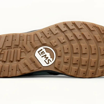 Brown rubber sole of a shoe with a Lems logo