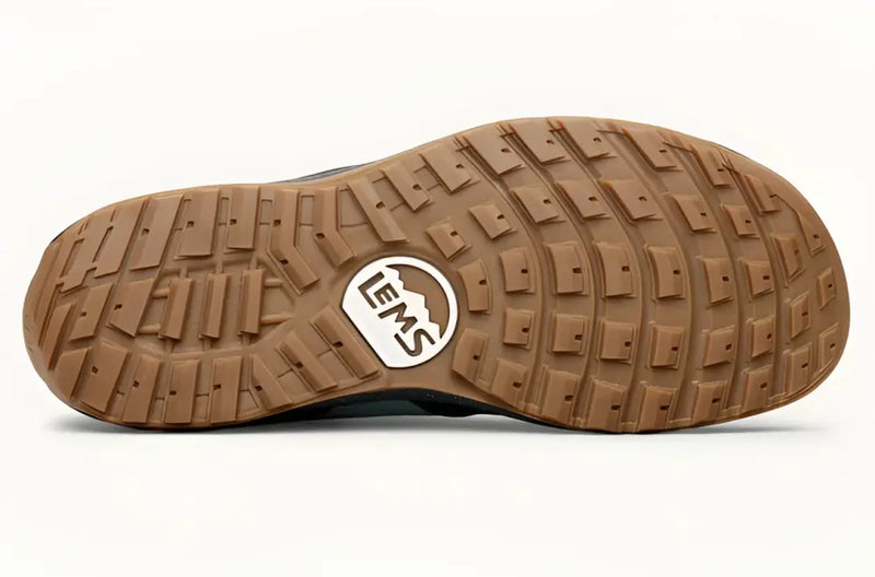 Brown rubber sole of a shoe with a Lems logo