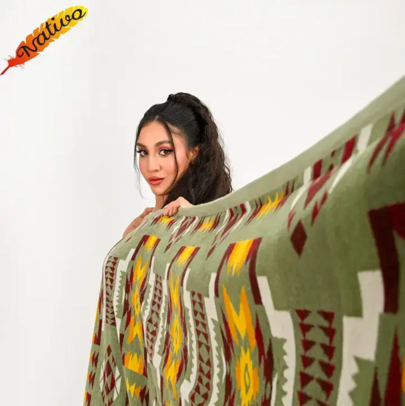 Woman holding up a green, yellow, and red patterned blanket