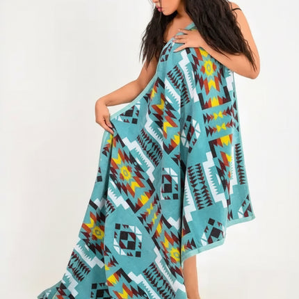 Woman holding a blue, yellow, red, and black patterned blanket