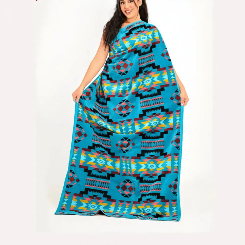Woman holding up a large blue blanket with a colorful geometric pattern