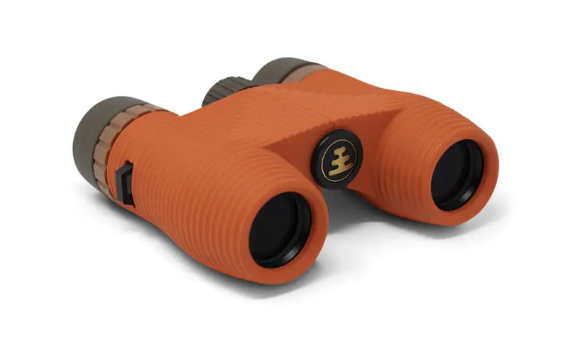 Orange binoculars with black lenses and a gold logo on the side