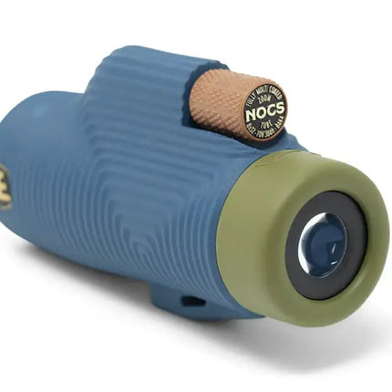 Blue and green monocular with a brown textured focus wheel