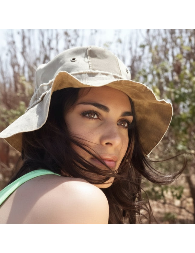 Woman wearing a bucket hat, looking over her shoulder