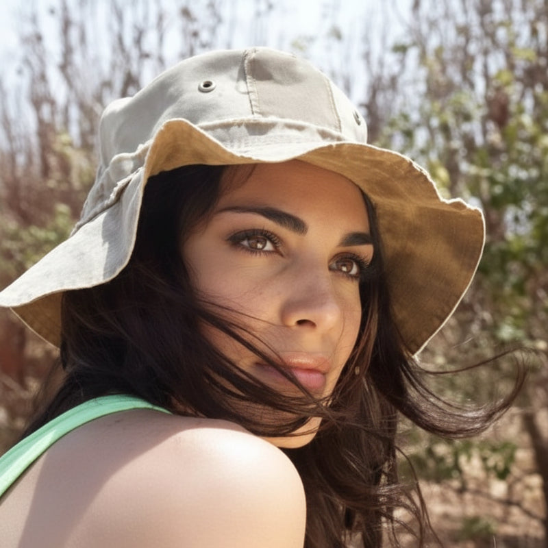 Woman wearing a bucket hat, looking over her shoulder