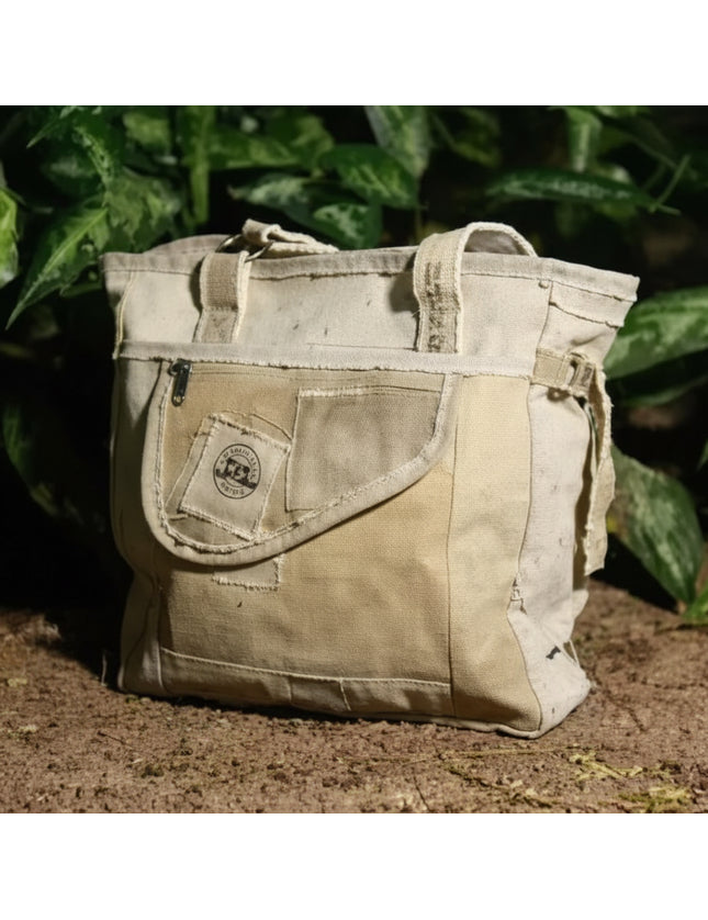 Beige canvas tote bag with front pocket and handles