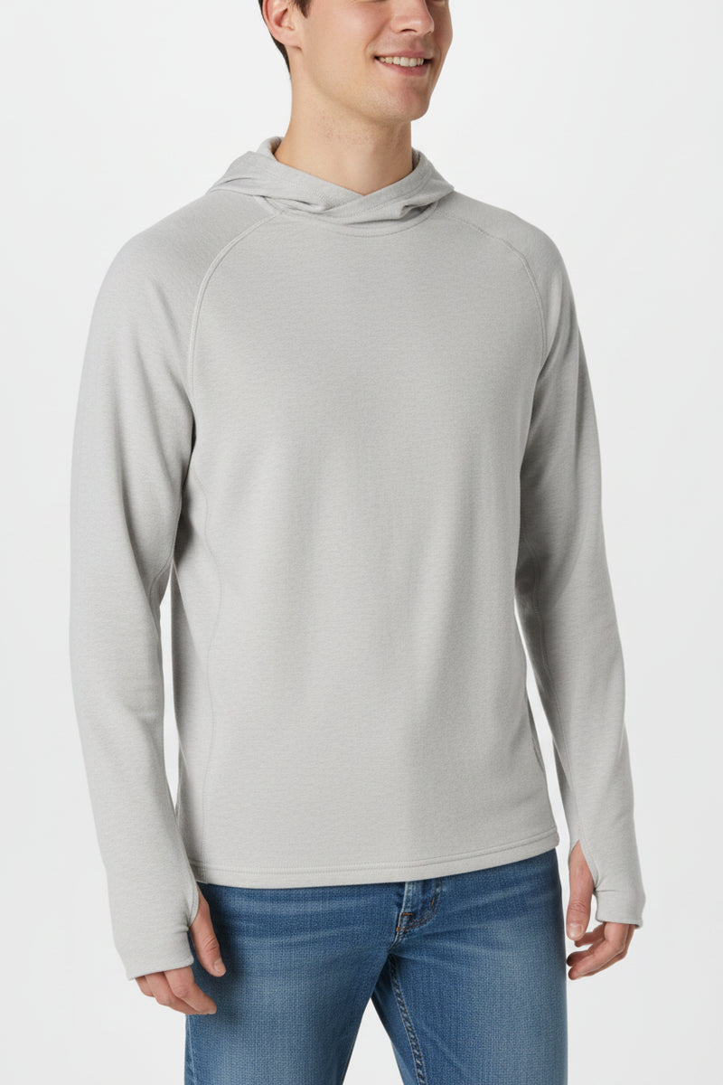 Man wearing a light grey long-sleeved hoodie with thumbholes