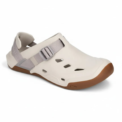 Cream colored water shoe with a brown sole and a gray adjustable strap