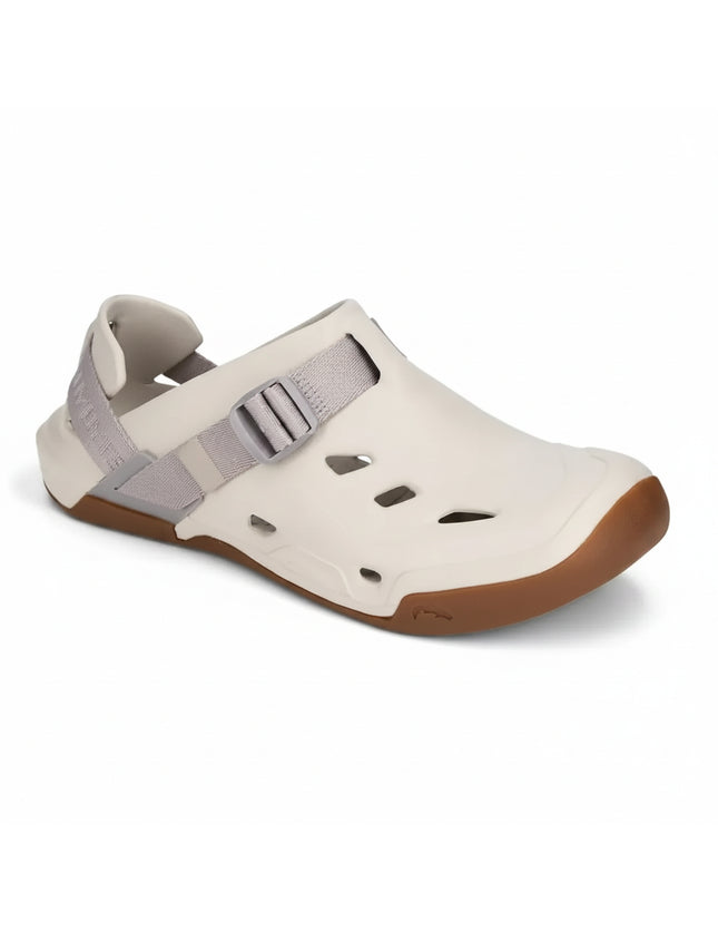 Cream colored water shoe with a brown sole and a gray adjustable strap