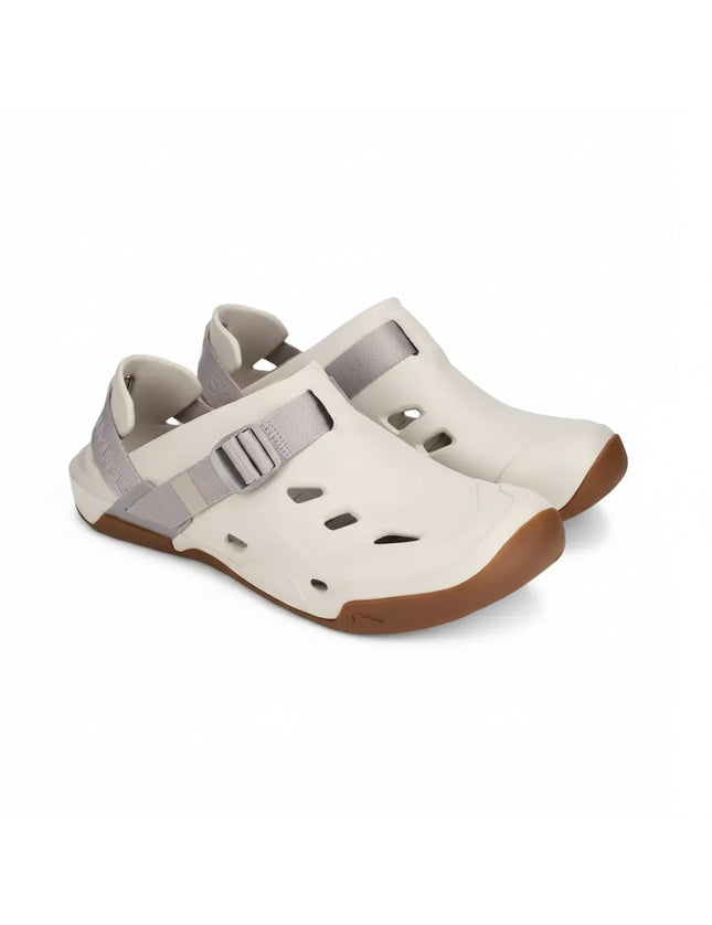 Pair of light beige closed-toe sandals with grey straps and brown soles