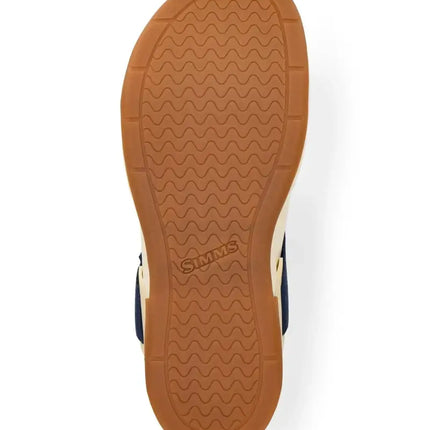 Underside of a sandal with a brown sole and the Simms logo