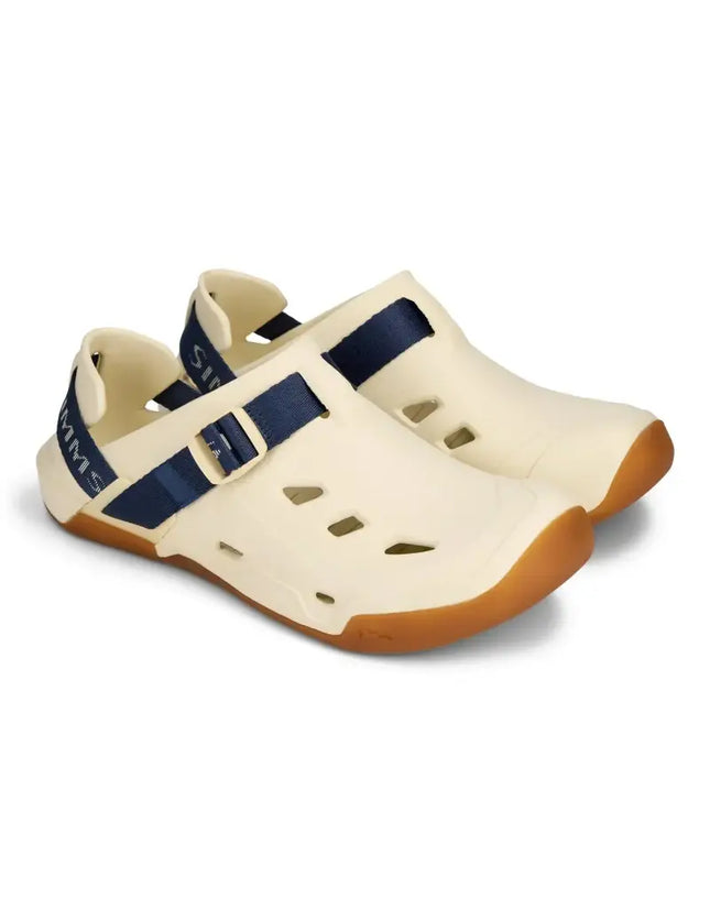 Pair of cream-colored wading sandals with navy blue straps and brown soles