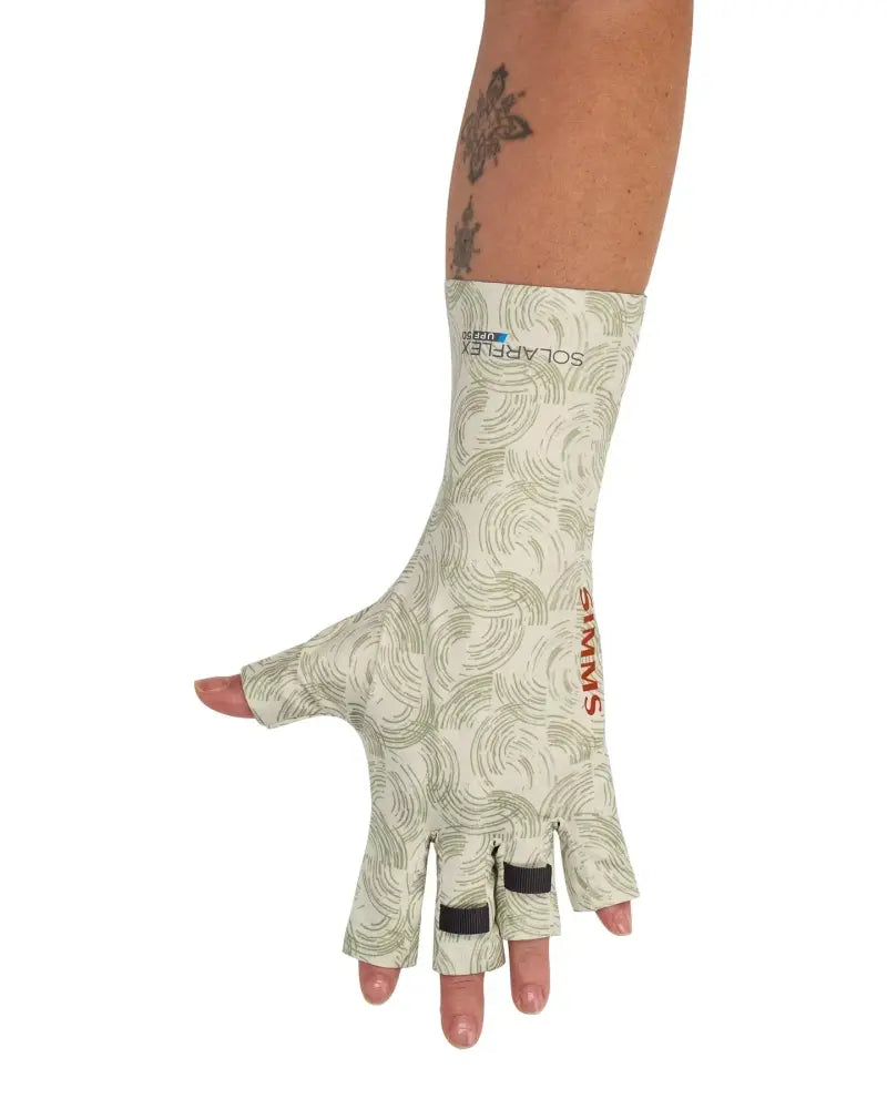 Arm wearing a cream-colored sun glove with a green swirl pattern and red Simms logo