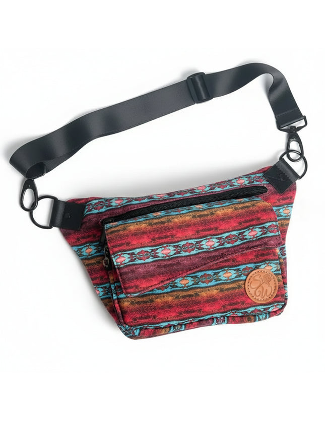 Red and blue patterned fanny pack with black strap and brown leather logo