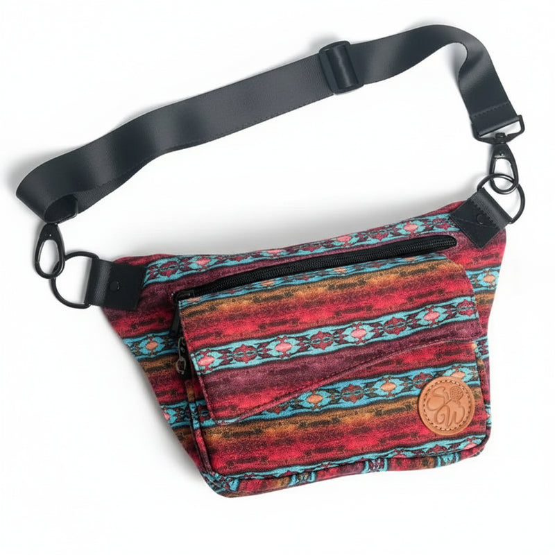 Red and blue patterned fanny pack with black strap and brown leather logo