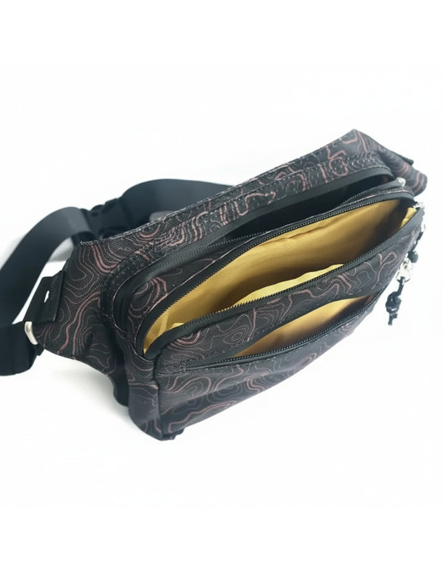 Black fanny pack with a topographic map pattern and yellow interior lining