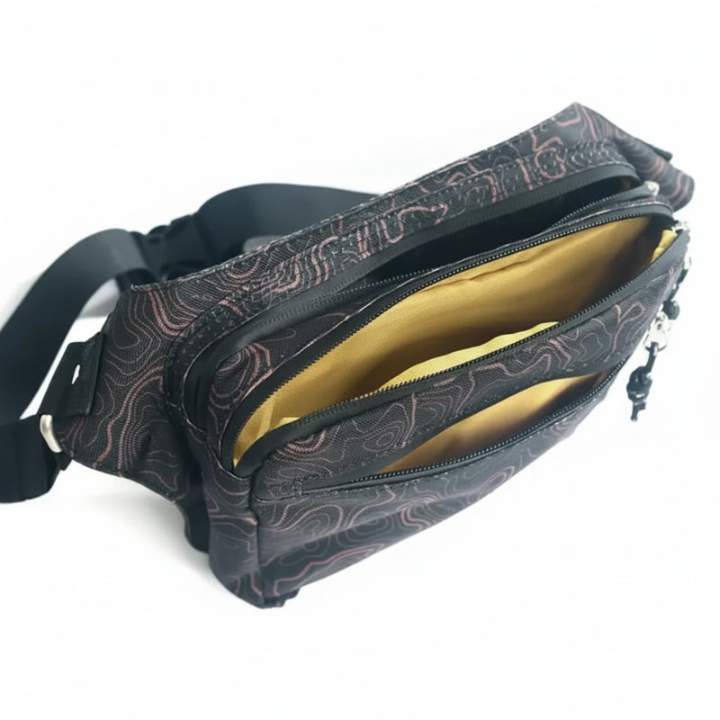 Black fanny pack with a topographic map pattern and yellow interior lining