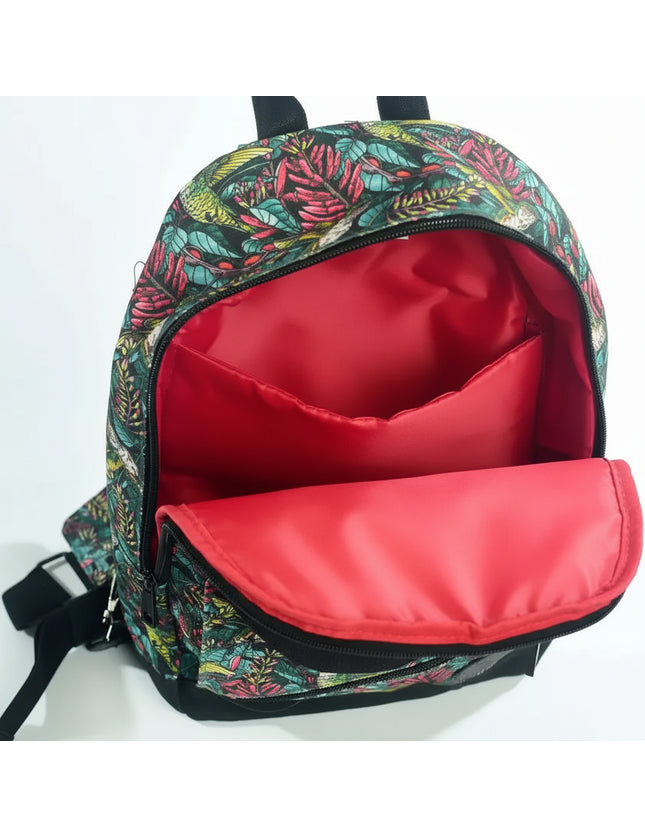 Open backpack with a red interior lining and a tropical leaf pattern on the exterior