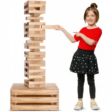 Girl in red shirt and black skirt playing with a large wooden block tower