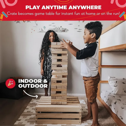 Two children playing a stacking block game on a wooden crate