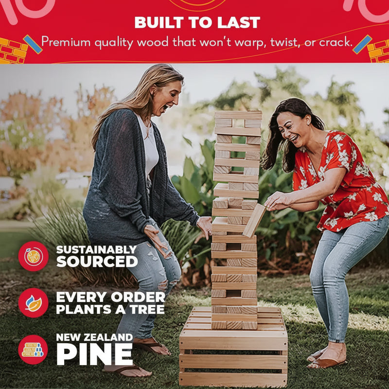 Two women playing a giant wooden block stacking game outdoors
