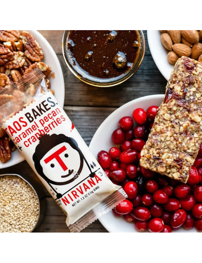 Taos Bakes Nirvana bar with caramel pecan and cranberries, surrounded by ingredients