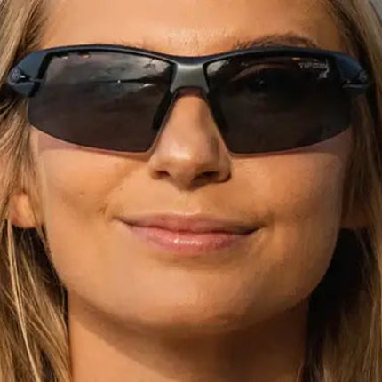 Woman with blonde hair wearing black sunglasses