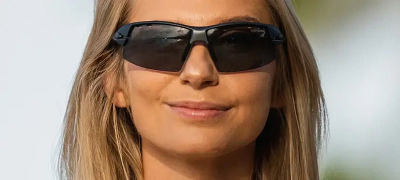 Woman with blonde hair wearing black sunglasses