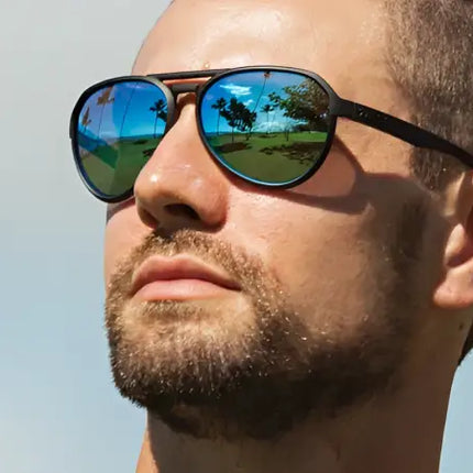 Man wearing black frame sunglasses with blue reflective lenses