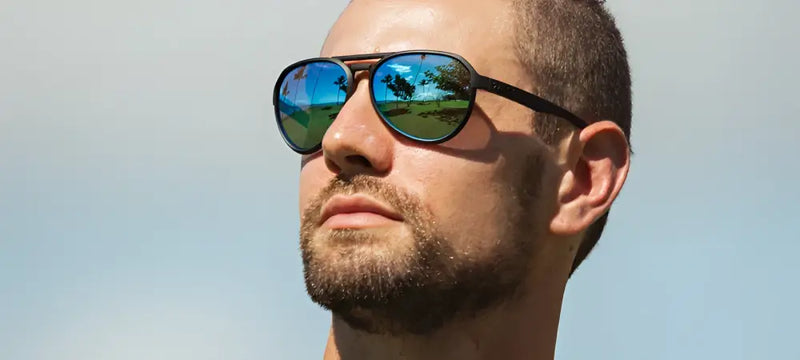 Man wearing black frame sunglasses with blue reflective lenses