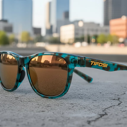 Teal and black tortoiseshell sunglasses with bronze lenses and Tifosi logo on the arm