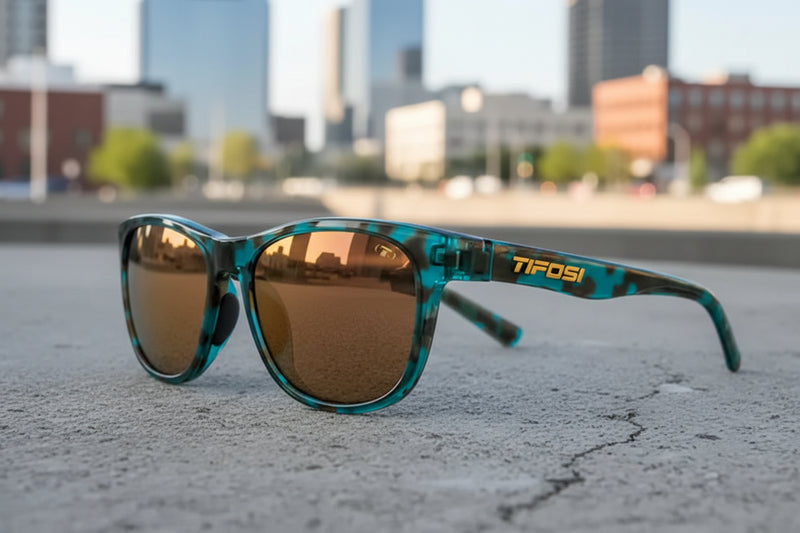 Teal and black tortoiseshell sunglasses with bronze lenses and Tifosi logo on the arm