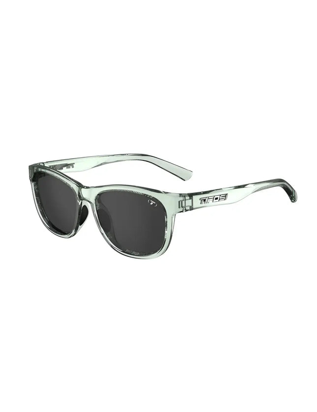 Light green sunglasses with dark lenses and the Tifosi logo on the side