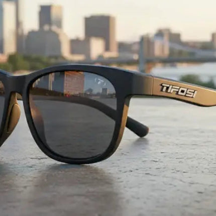 Black Tifosi sunglasses with city skyline reflected in lenses