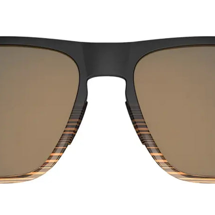 Black sunglasses with brown lenses and striped lower frames