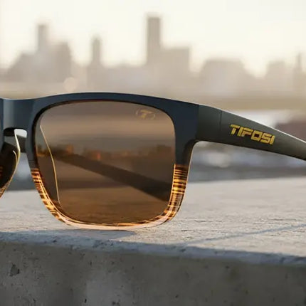 Tifosi sunglasses with brown lenses and a subtle orange grid pattern on the lower frame