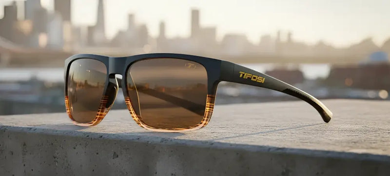 Tifosi sunglasses with brown lenses and a subtle orange grid pattern on the lower frame