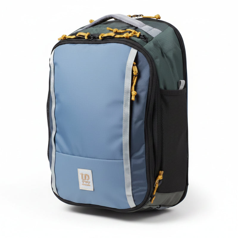 Blue and green backpack with yellow zipper pulls and a small square logo on the front