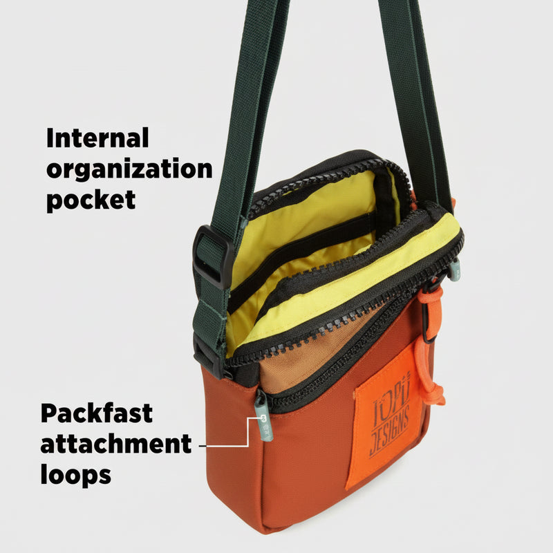 Orange and black bag with yellow lining and internal organization pocket and packfast attachment loops