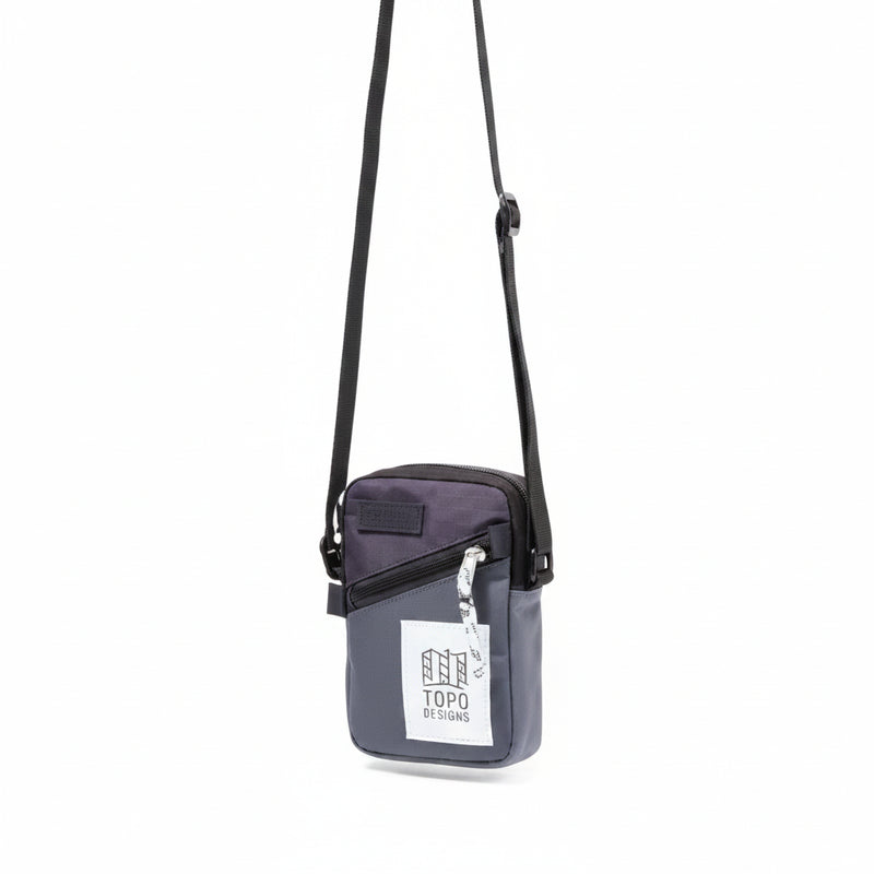 Topo Designs Global Shoulder Bag in charcoal and black with a white tag